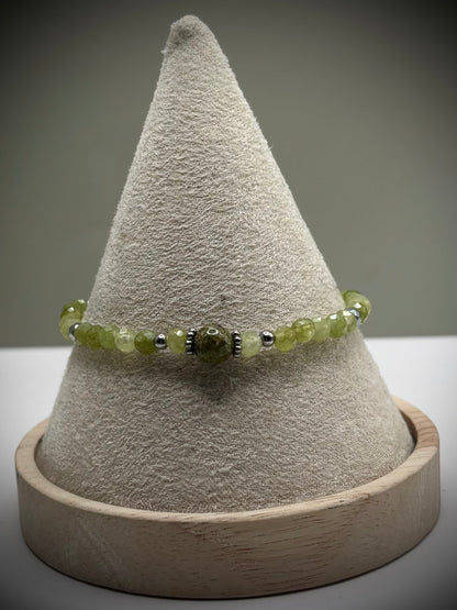 Ръчно изработена гривна от естествен перидот с фасетирани мъниста и метален елемент, елегантно бижу в свеж зелен цвят и фин блясък